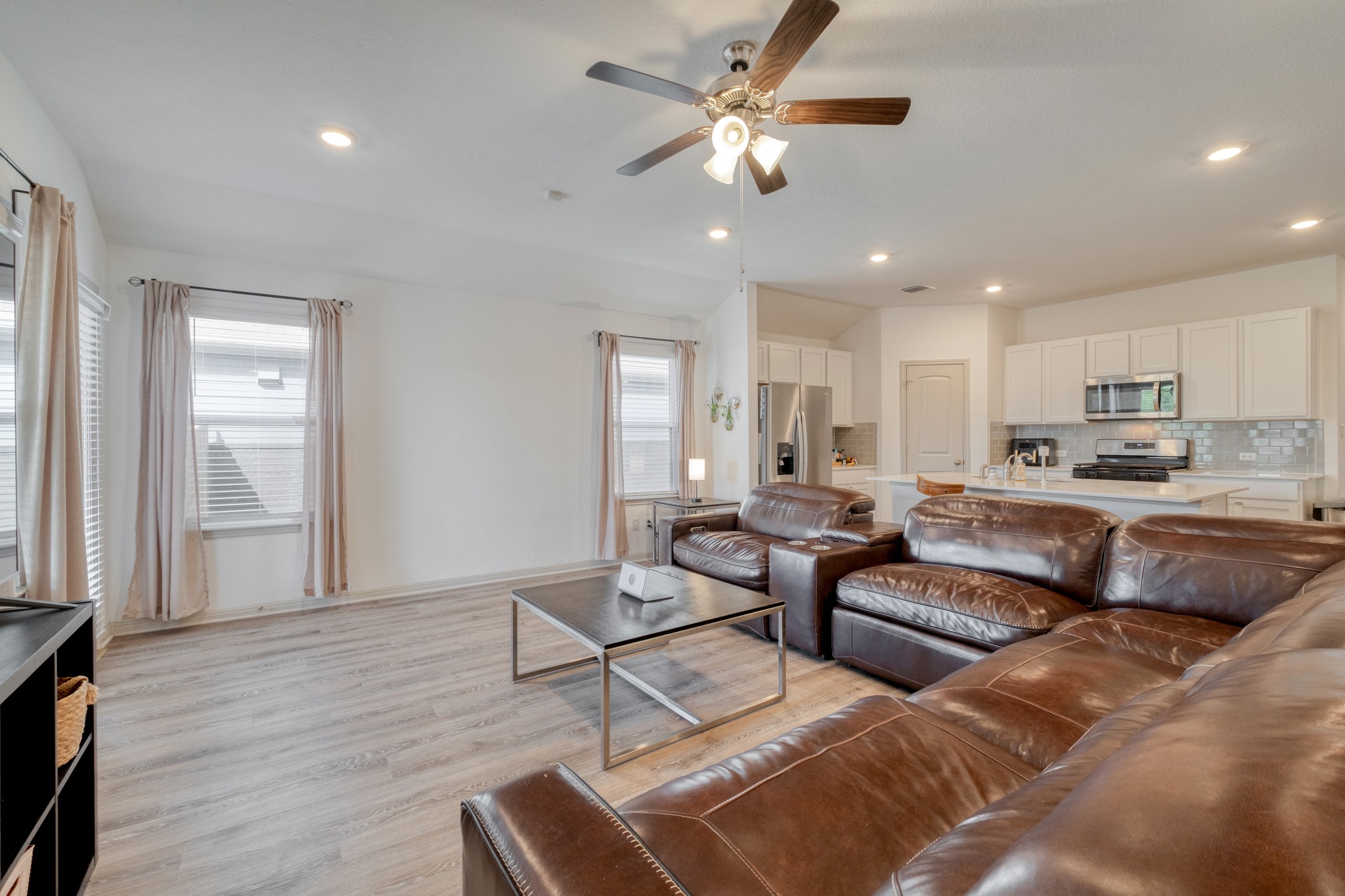 102 Johnson Draw Road Hutto, TX 78634 - Photo 29 of 30 An open floorplan seamlessly connects the airy living area to the modern kitchen.