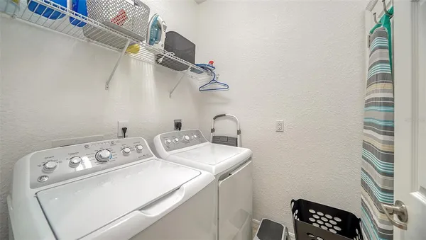 a bathroom with a granite countertop sink and a large mirror