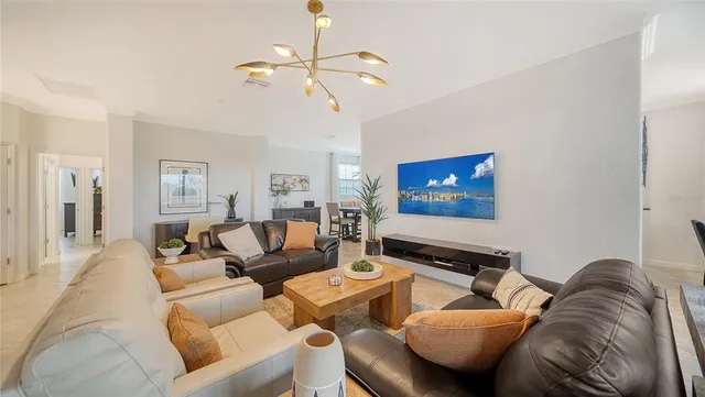a living room with furniture and a chandelier