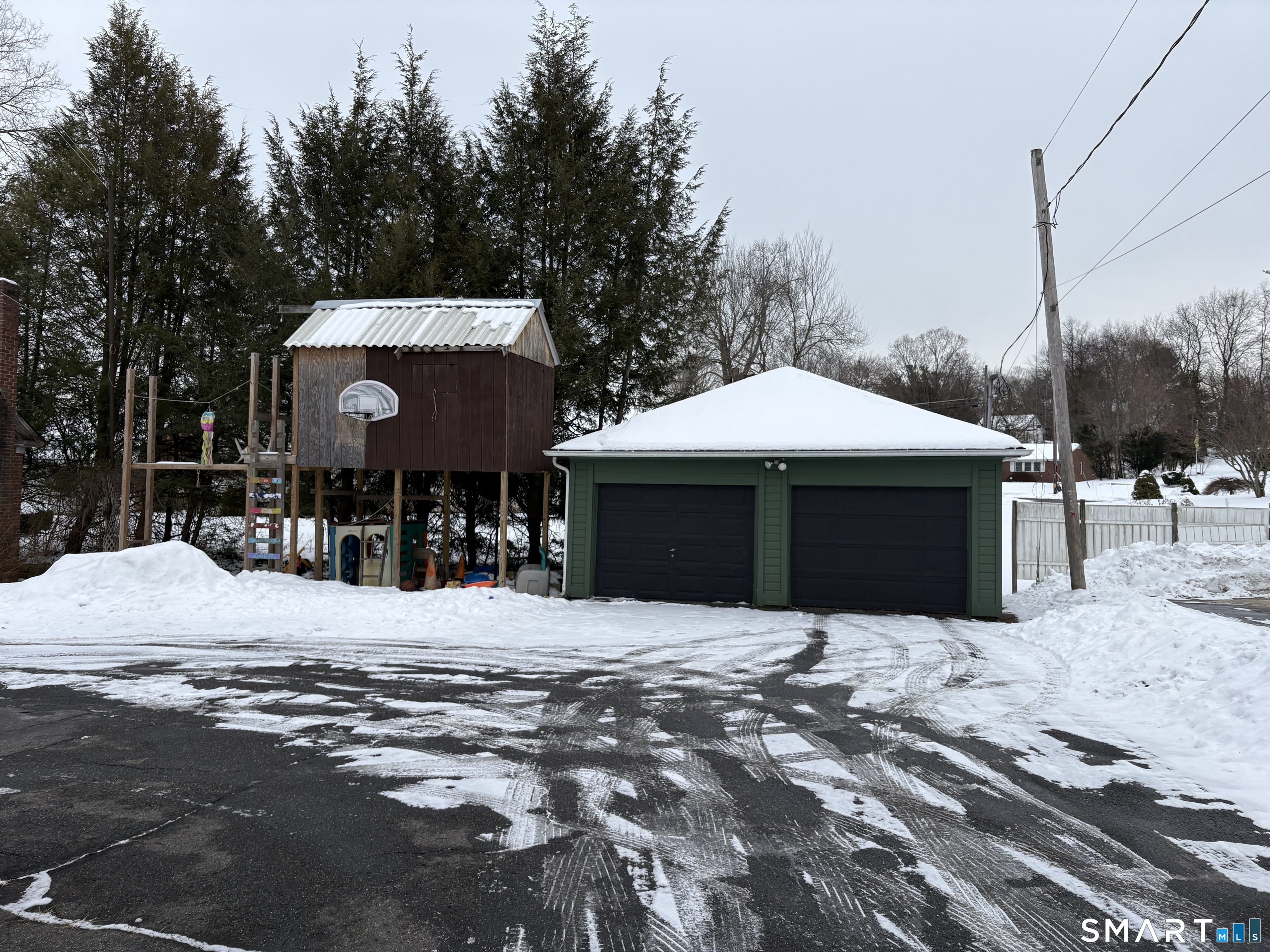 415 Litchfield Street Torrington, CT 06790 - Photo 23 of 23 a front view of a house with a yard covered with snow