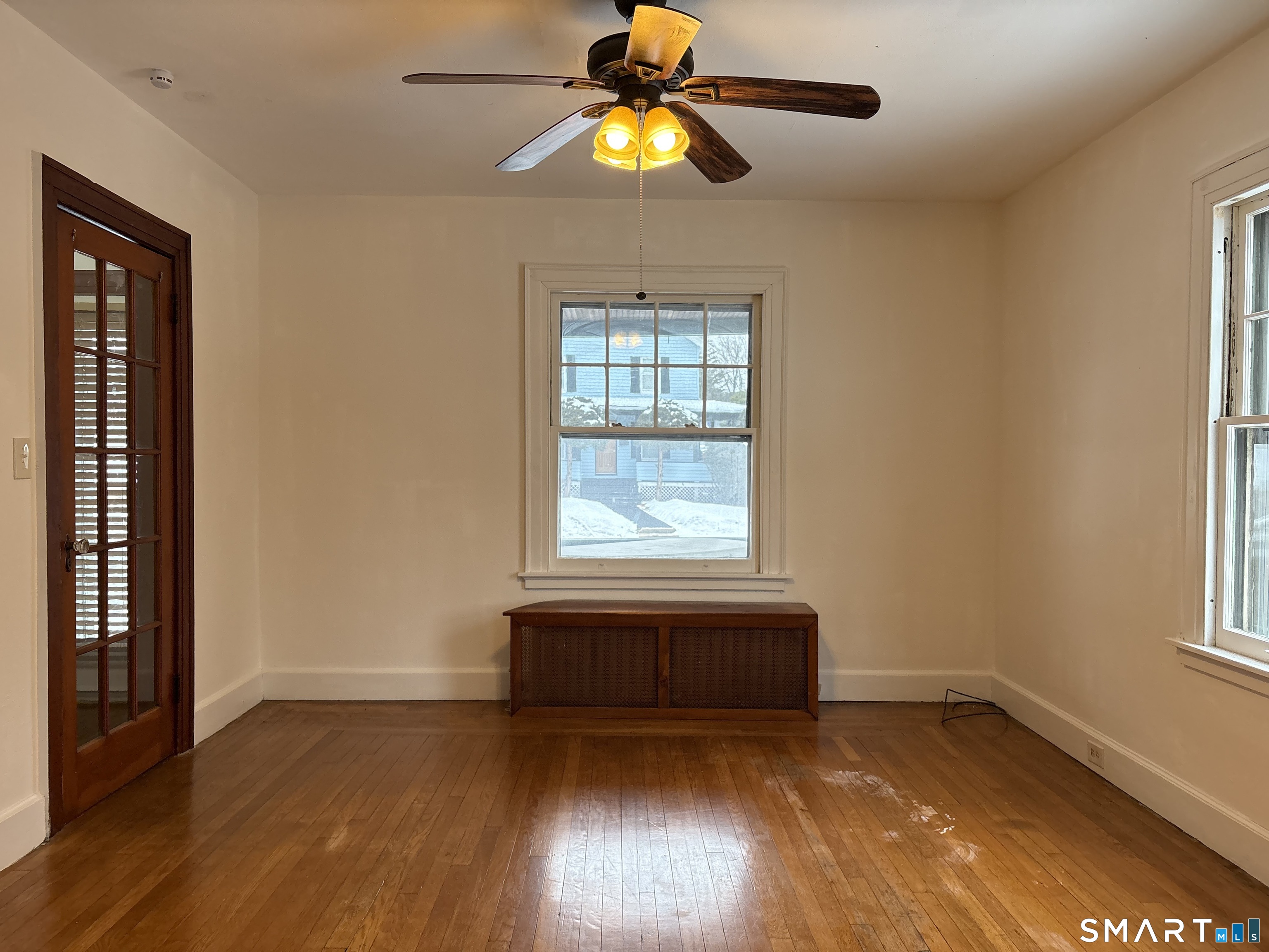 415 Litchfield Street Torrington, CT 06790 - Photo 3 of 23 an empty room with windows and fan