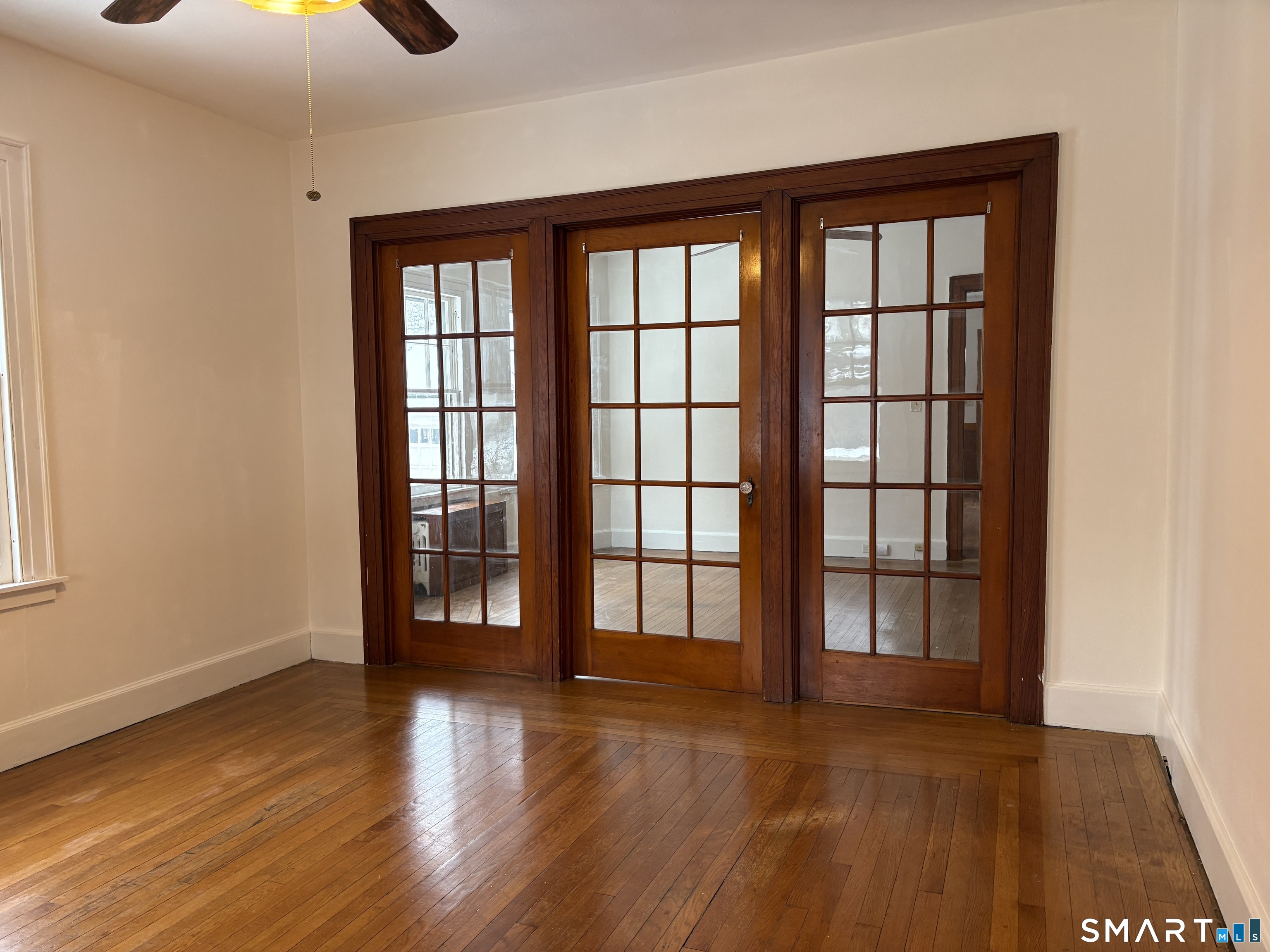 415 Litchfield Street Torrington, CT 06790 - Photo 4 of 23 wooden floor in an empty room with a window