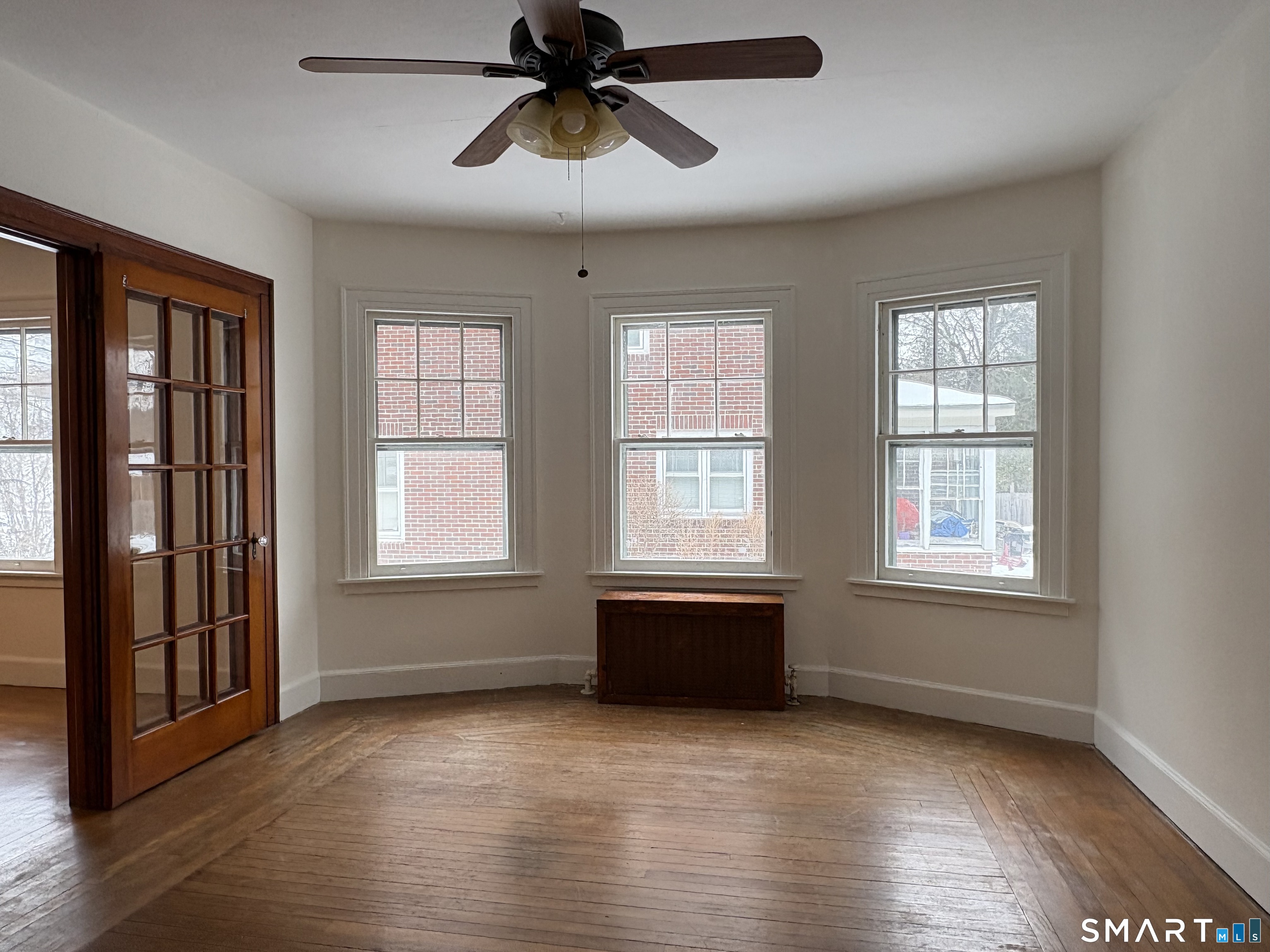 415 Litchfield Street Torrington, CT 06790 - Photo 5 of 23 a view of empty room with wooden floor and fan