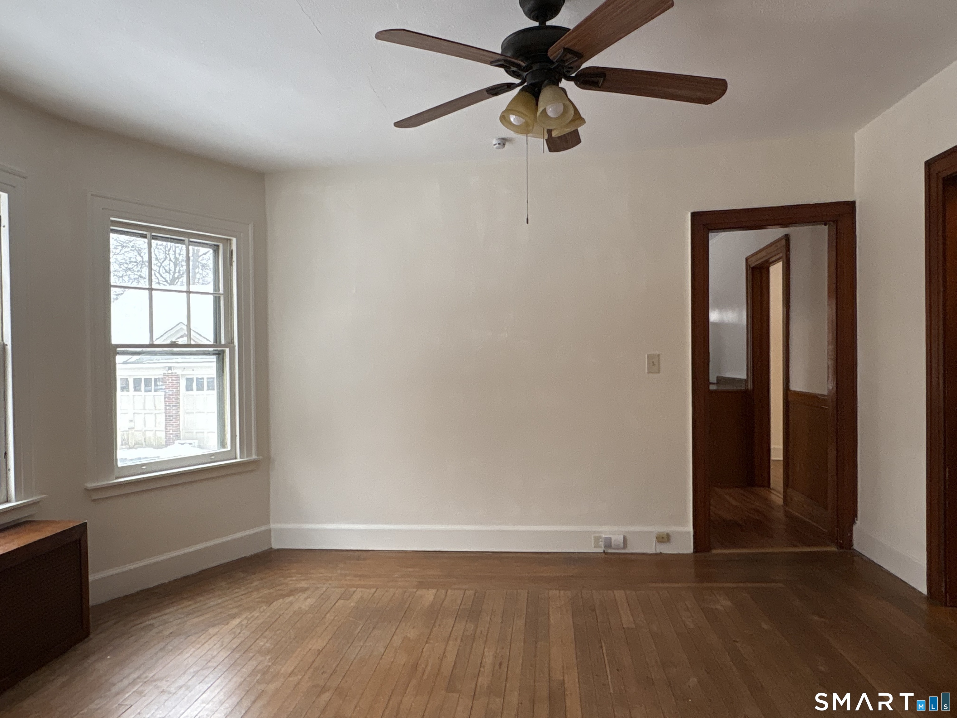 415 Litchfield Street Torrington, CT 06790 - Photo 6 of 23 an empty room with wooden floor closet and windows