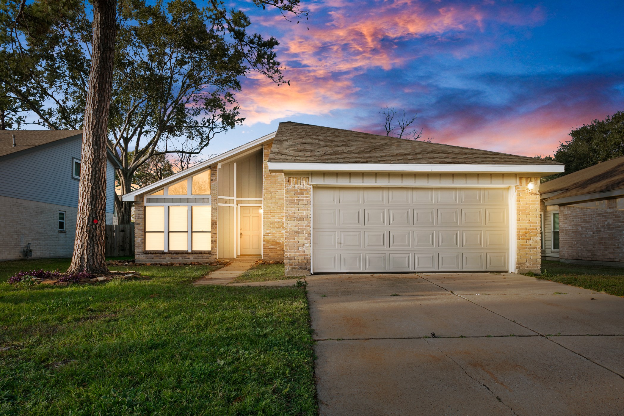 a backyard of a house with lots of green space and outdoor seating