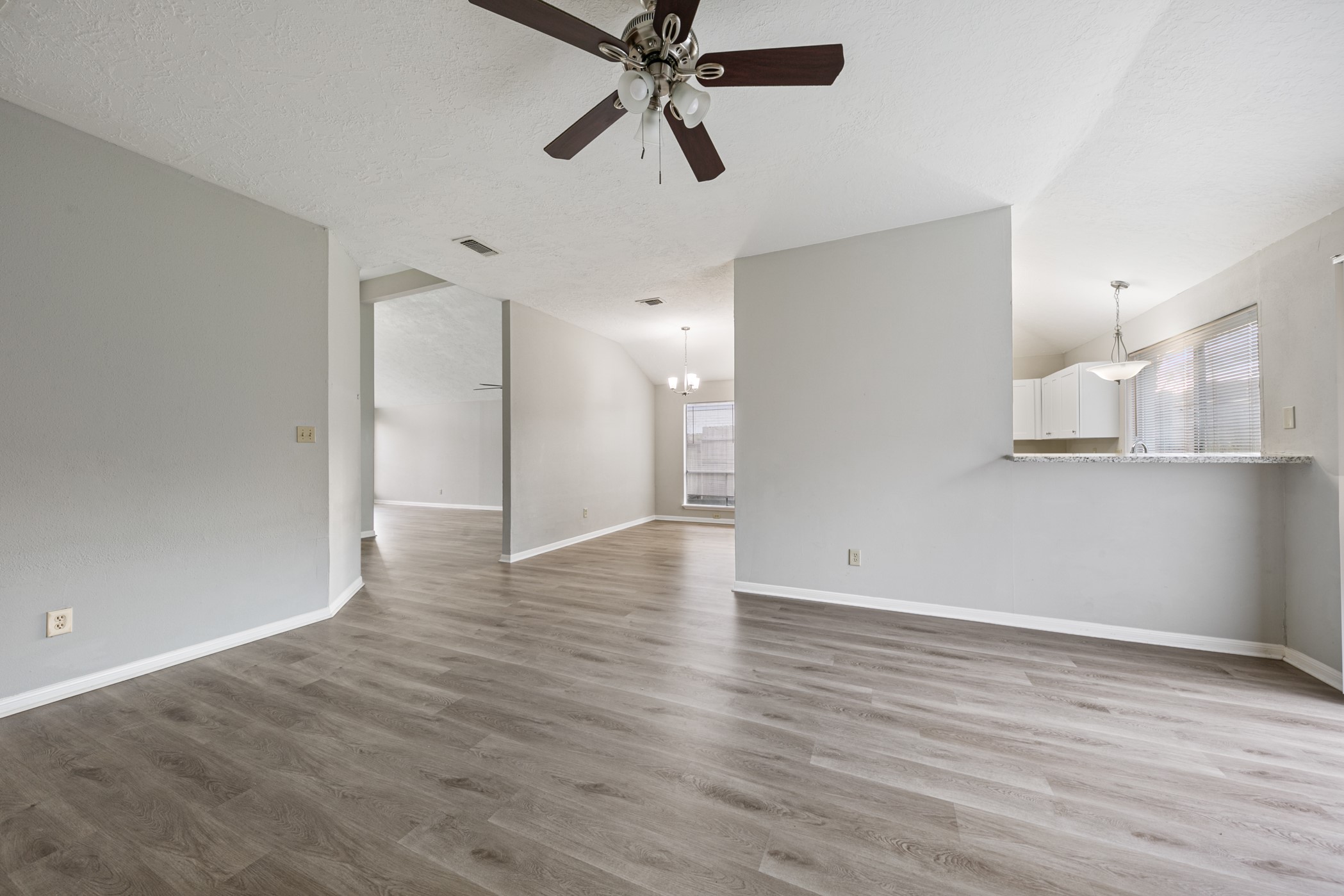 10530 Rippling Fields Drive Houston, TX 77064 - Photo 11 of 29 a view of a room with wooden floor and ceiling fan