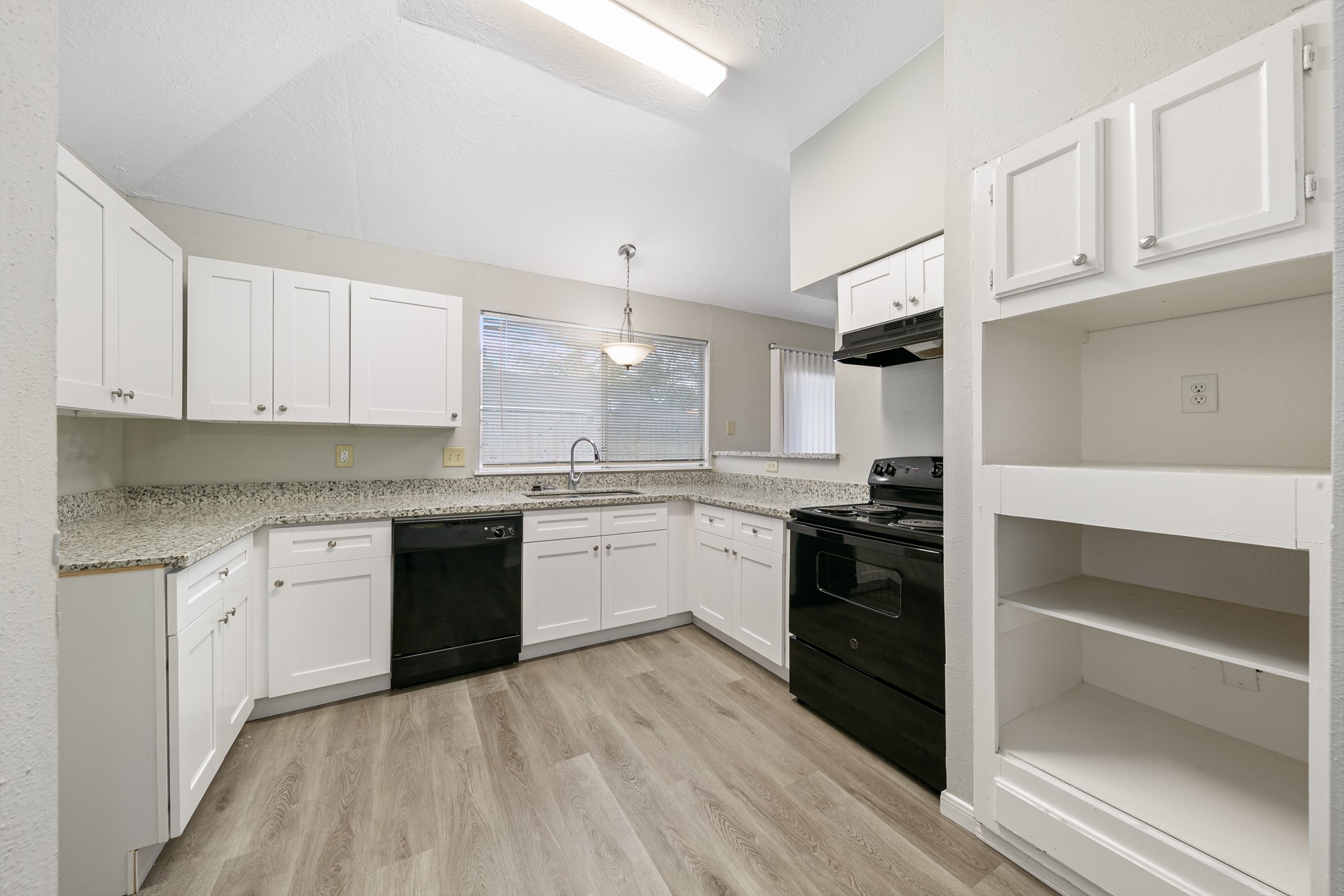 10530 Rippling Fields Drive Houston, TX 77064 - Photo 15 of 29 a kitchen with granite countertop white cabinets and appliances