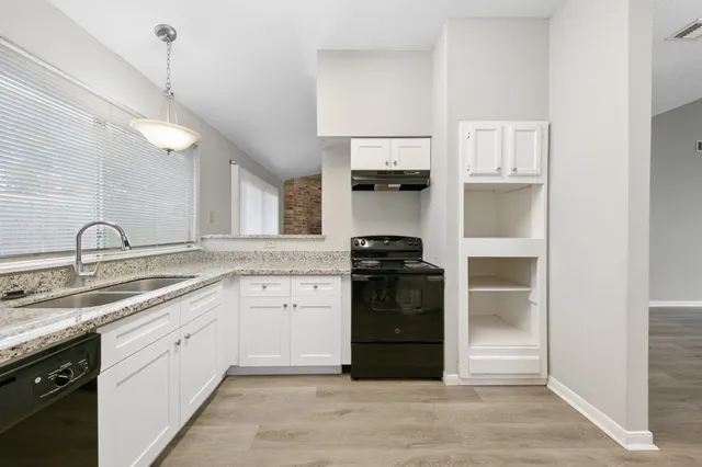 a kitchen with a sink and white stainless steel appliances