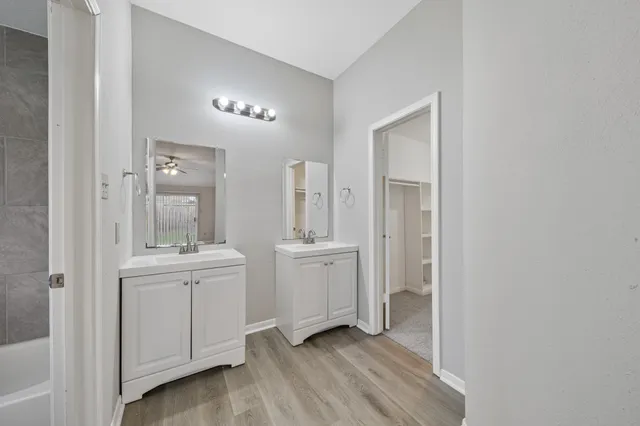 a bathroom with a sink a light fixture and a mirror