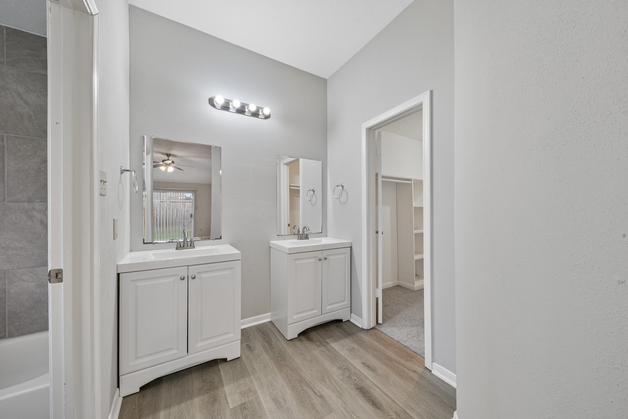 10530 Rippling Fields Drive Houston, TX 77064 - Photo 20 of 29 a bathroom with a sink a light fixture and a mirror