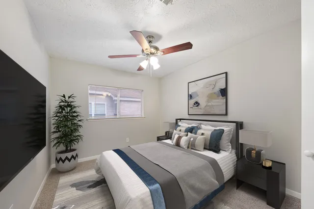 a bedroom with bed and a chandelier