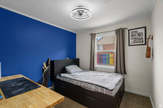 961 33rd Street Ogden, UT 84403 - Photo 17 of 39 Carpeted room with a single window, crown molding, and a modern ceiling light fixture