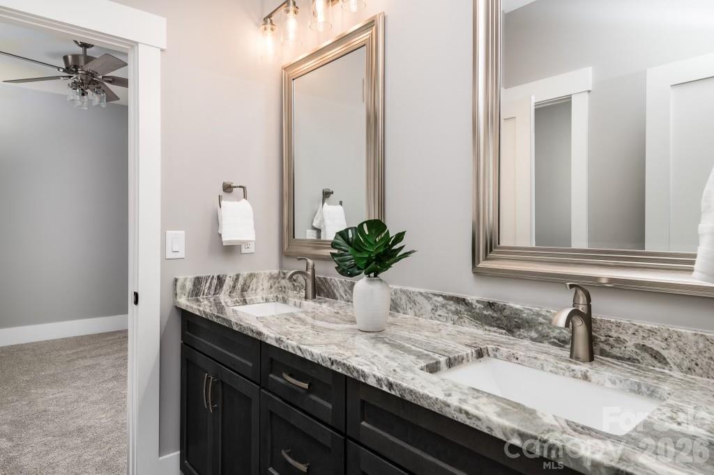 116 Silver Falls Road Troutman, NC 28166 - Photo 41 of 46 a bathroom with a granite countertop sink and a mirror