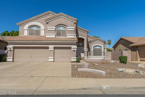 a kitchen with stainless steel appliances granite countertop a stove top oven a sink dishwasher a refrigerator and cabinets with wooden floor
