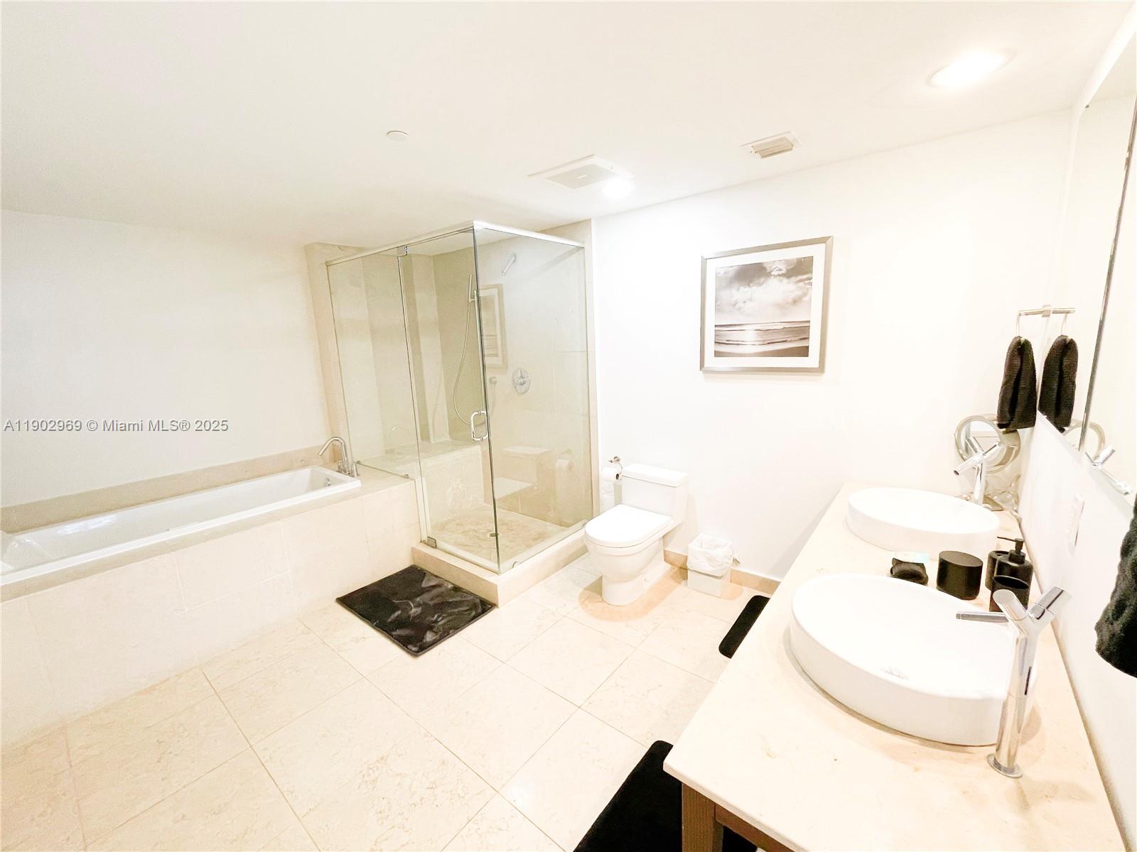 485 Brickell Avenue, Unit 2602 Miami, FL 33131 - Photo 11 of 19 a bathroom with a sink and a mirror