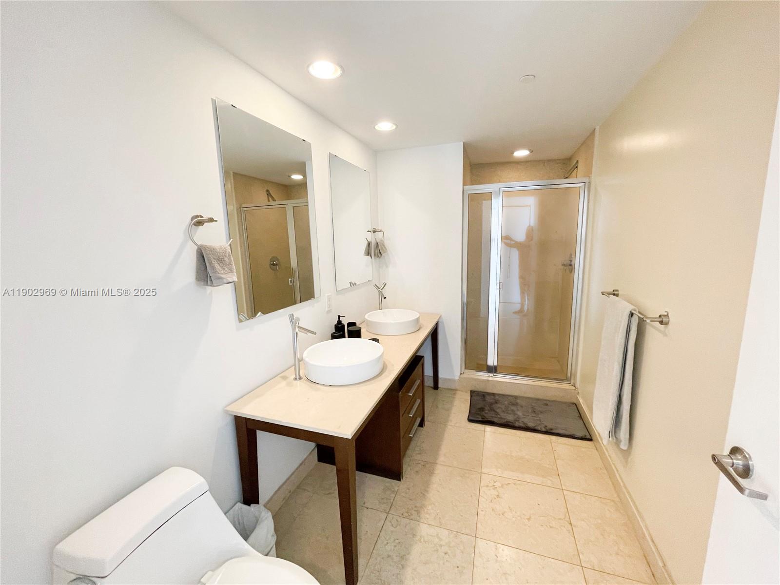 485 Brickell Avenue, Unit 2602 Miami, FL 33131 - Photo 14 of 19 a bathroom with a sink a toilet a mirror and vanity