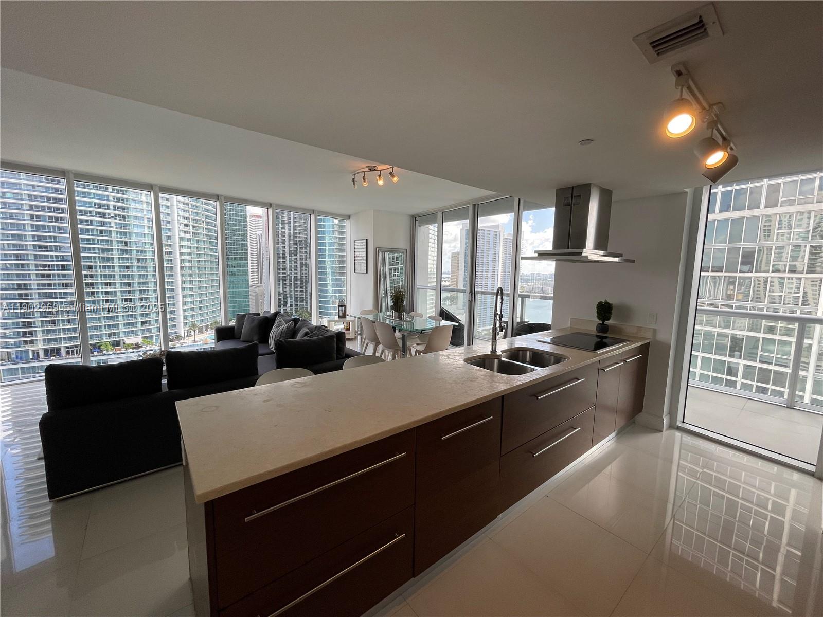 485 Brickell Avenue, Unit 2602 Miami, FL 33131 - Photo 16 of 19 a large kitchen with stainless steel appliances a stove a sink a microwave and a refrigerator