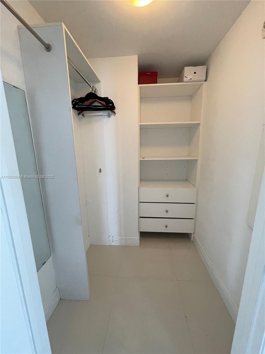 485 Brickell Avenue, Unit 2602 Miami, FL 33131 - Photo 18 of 19 a view of walk in closet with empty racks