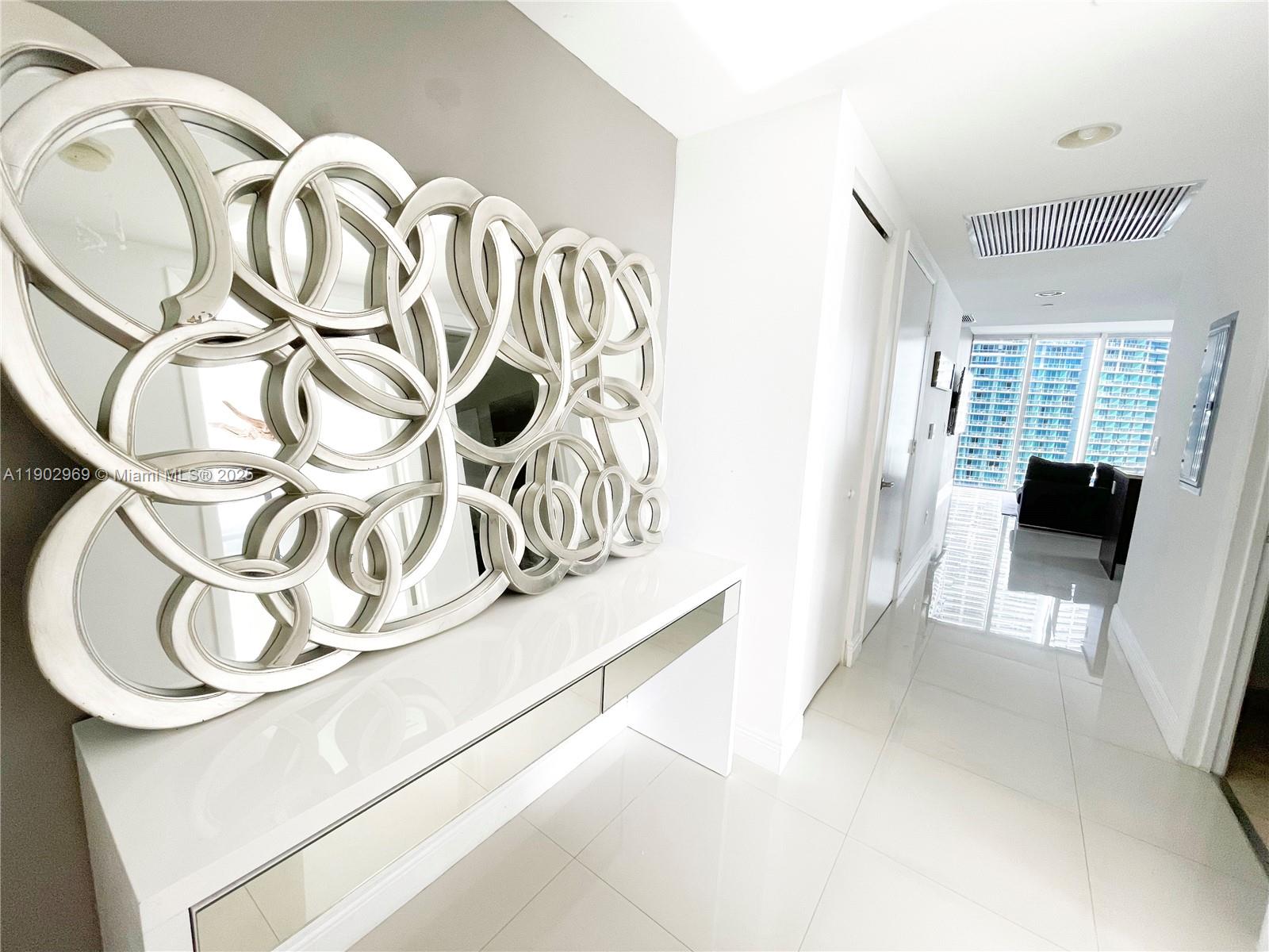 485 Brickell Avenue, Unit 2602 Miami, FL 33131 - Photo 3 of 19 a view of an entryway with a table and chair