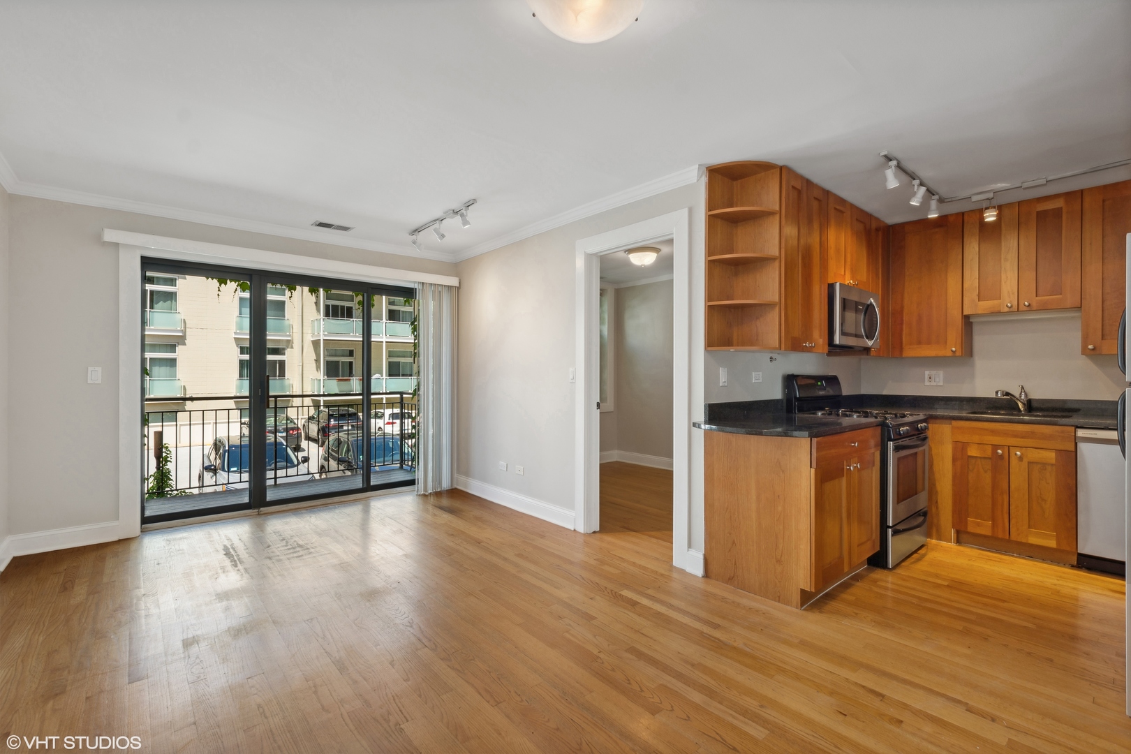 4144 North Sheridan Road, Unit 205 Chicago, IL 60613 - Photo 4 of 18 a view of kitchen with stainless steel appliances granite countertop a stove top oven a sink and a granite counter tops with wooden floors