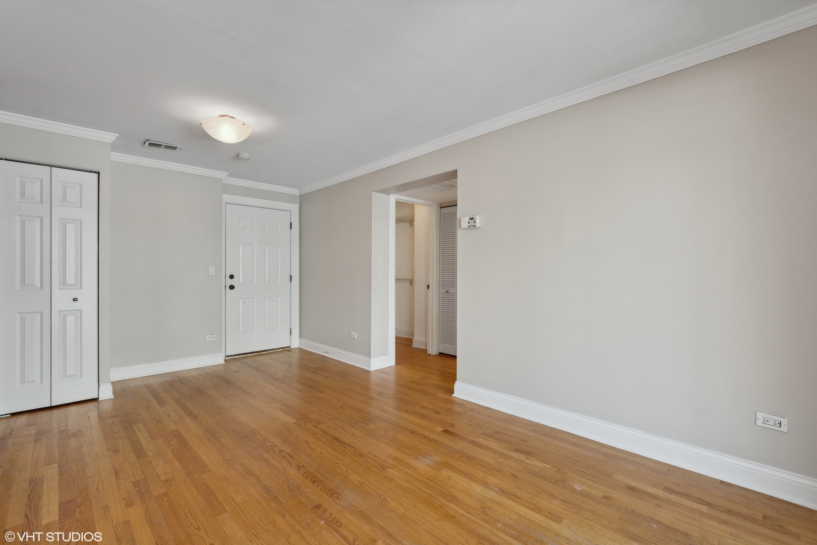 4144 North Sheridan Road, Unit 205 Chicago, IL 60613 - Photo 6 of 18 a view of an empty room with wooden floor