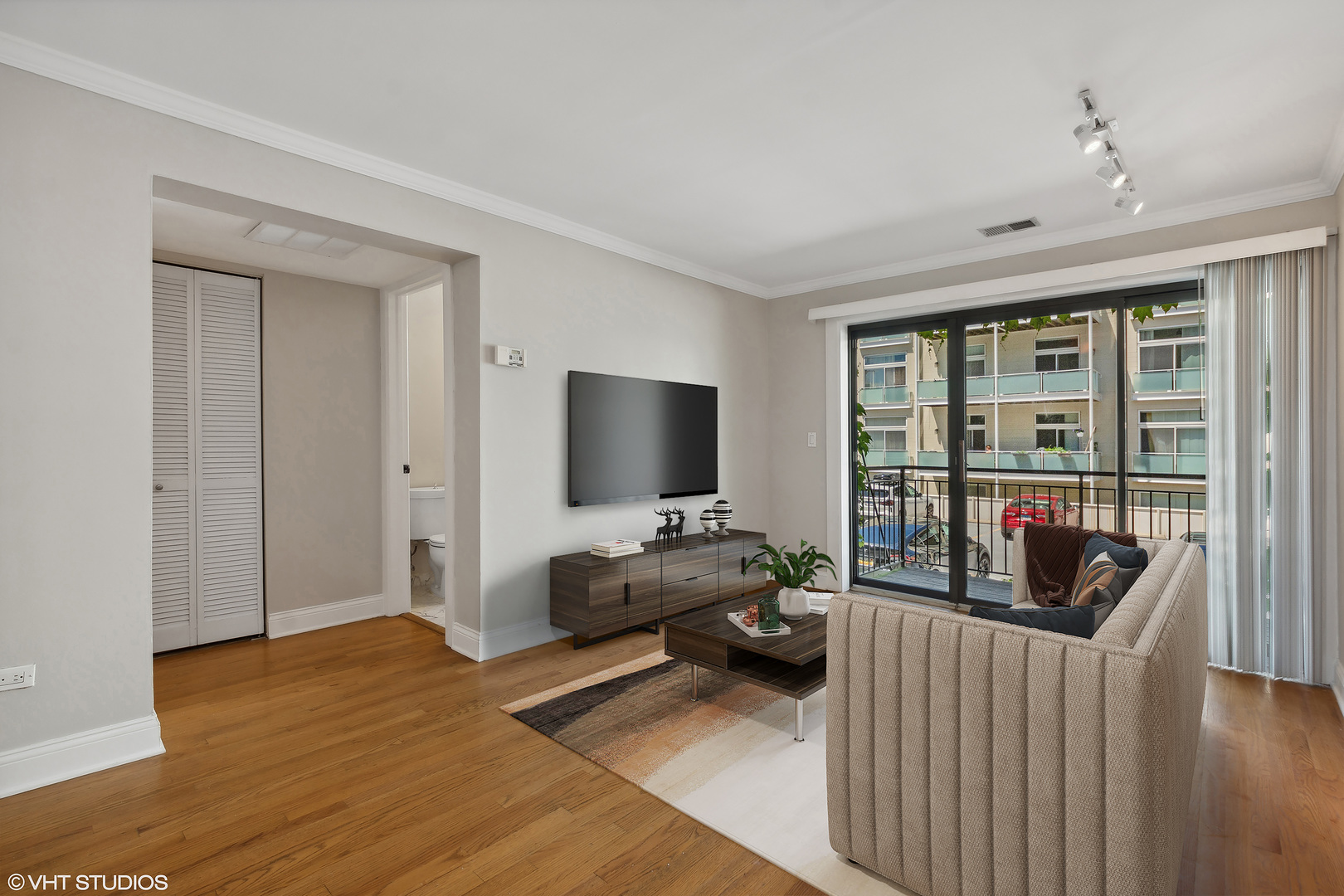 4144 North Sheridan Road, Unit 205 Chicago, IL 60613 - Photo 8 of 18 a living room with furniture and a flat screen tv