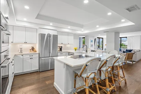 a kitchen with appliances a sink and cabinets