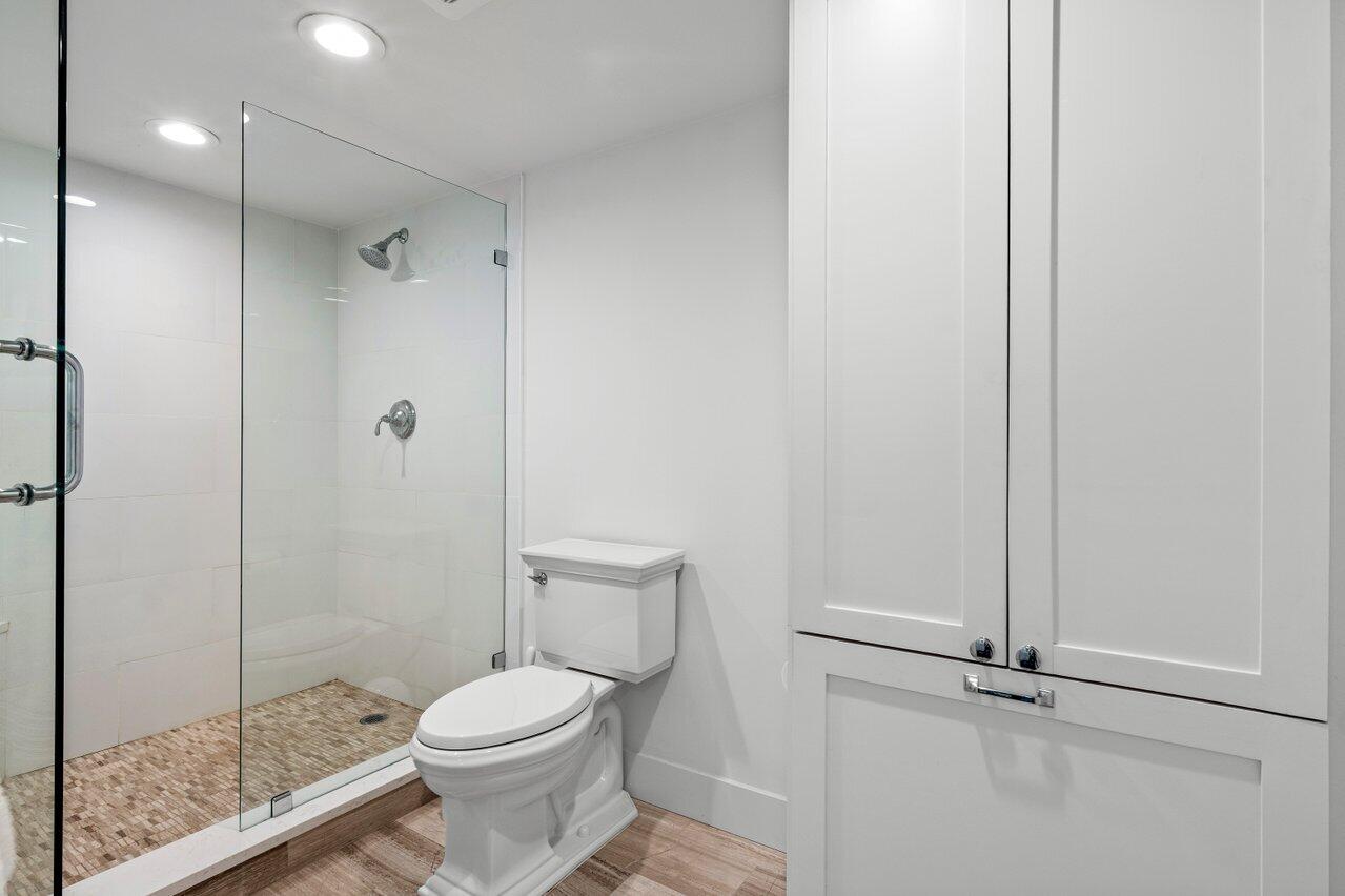176 Helios Drive, Unit 104 Jupiter, FL 33477 - Photo 16 of 59 a bathroom with a toilet and a shower