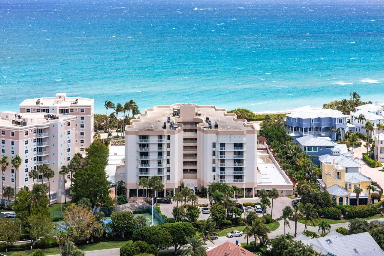 176 Helios Drive, Unit 104 Jupiter, FL 33477 - Photo 2 of 59 a view of a building with a garden