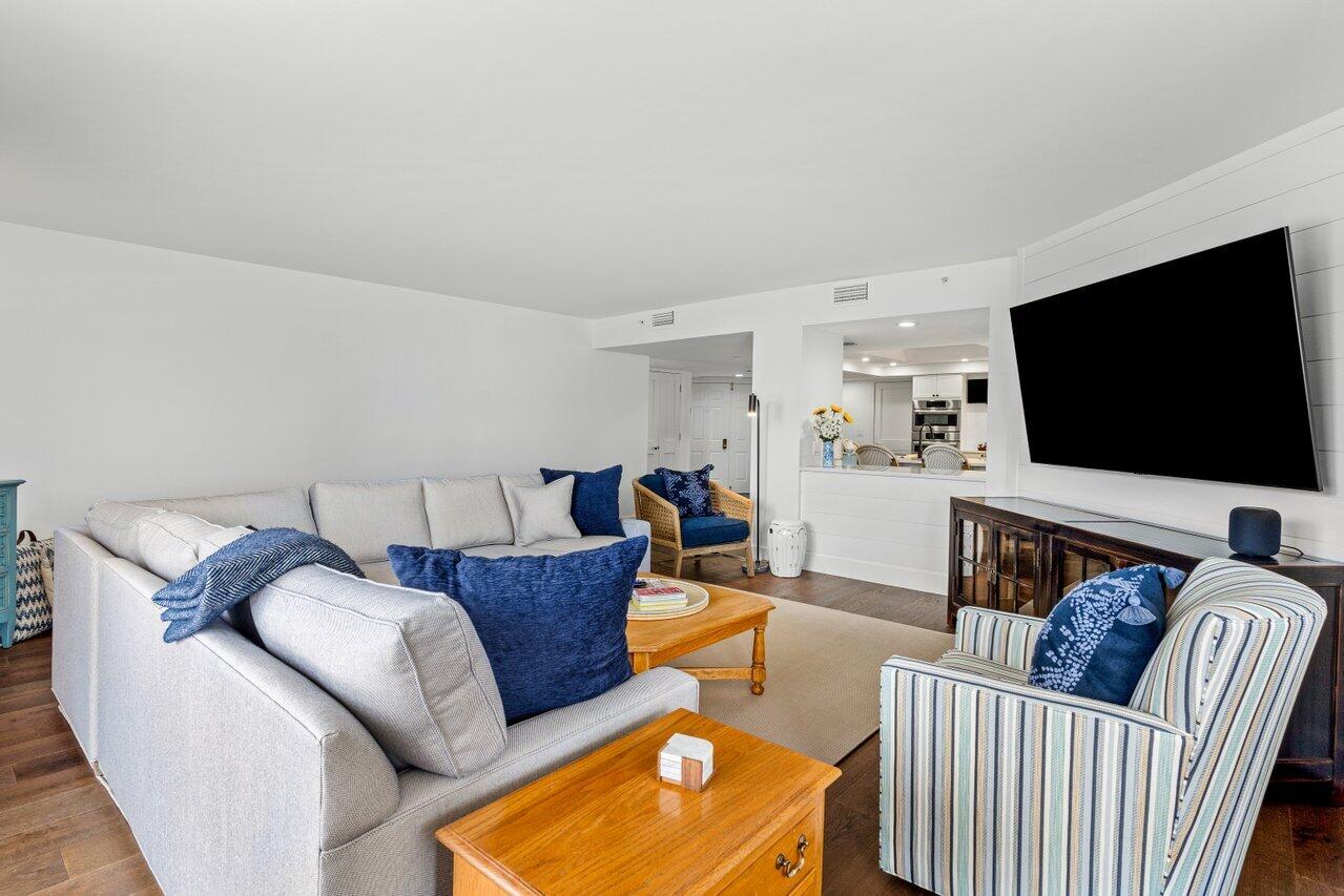 176 Helios Drive, Unit 104 Jupiter, FL 33477 - Photo 25 of 59 a living room with furniture and a flat screen tv