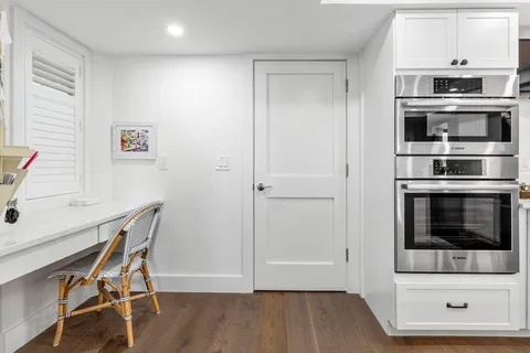 a bedroom with a bed tv and a window