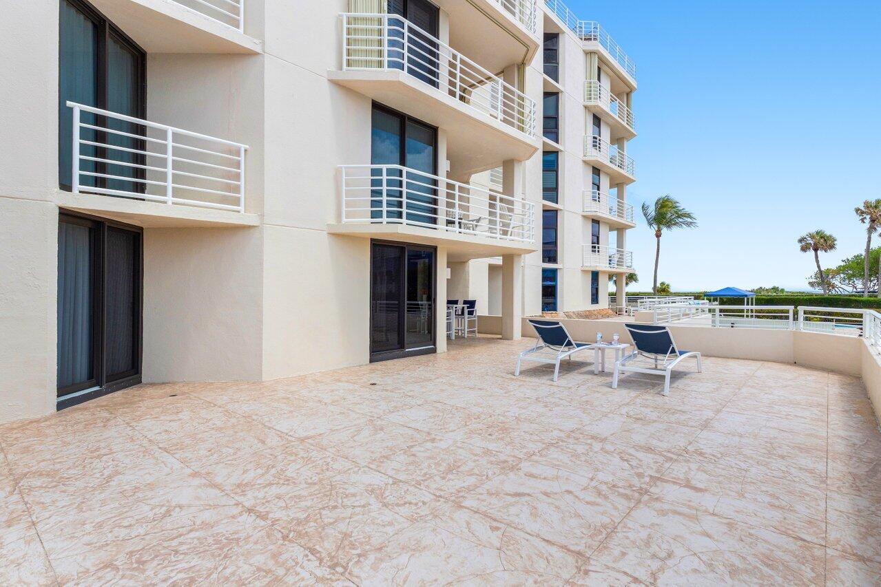 176 Helios Drive, Unit 104 Jupiter, FL 33477 - Photo 37 of 59 a view of a building with sitting area