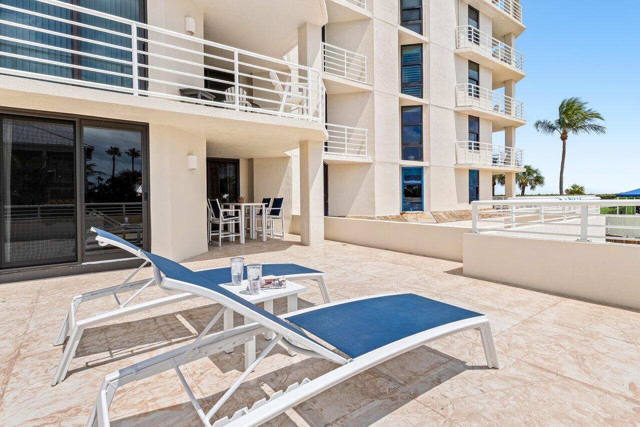 176 Helios Drive, Unit 104 Jupiter, FL 33477 - Photo 38 of 59 front view of a building with a outdoor space