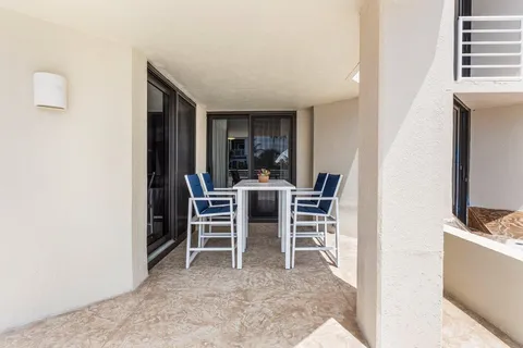 a view of a patio with couches table and chairs and potted plants