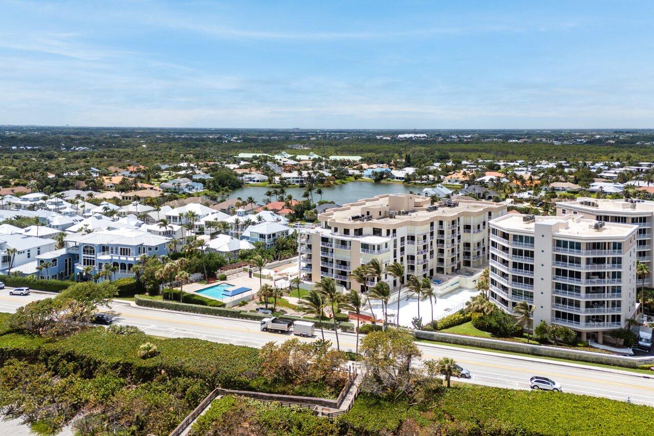 176 Helios Drive, Unit 104 Jupiter, FL 33477 - Photo 52 of 59 an aerial view of residential building and lake view
