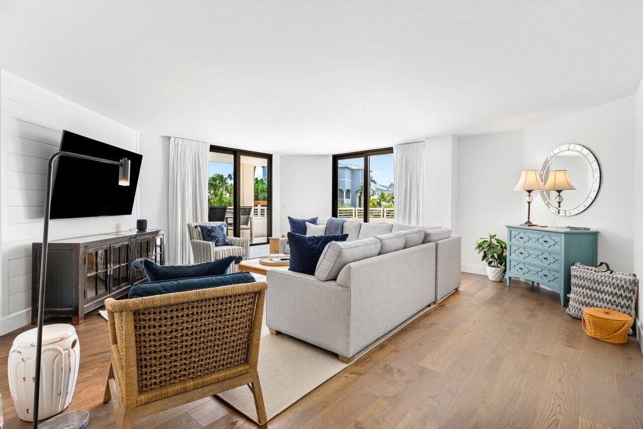 176 Helios Drive, Unit 104 Jupiter, FL 33477 - Photo 8 of 59 a living room with furniture and a flat screen tv