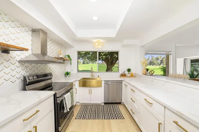 a kitchen with a sink and a stove top oven