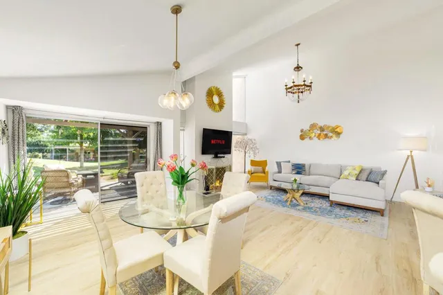 a living room with patio furniture and a fireplace