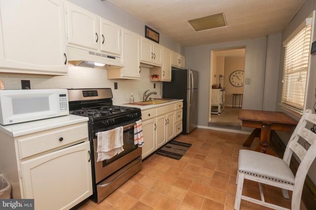 a kitchen with stainless steel appliances white cabinets and a stove