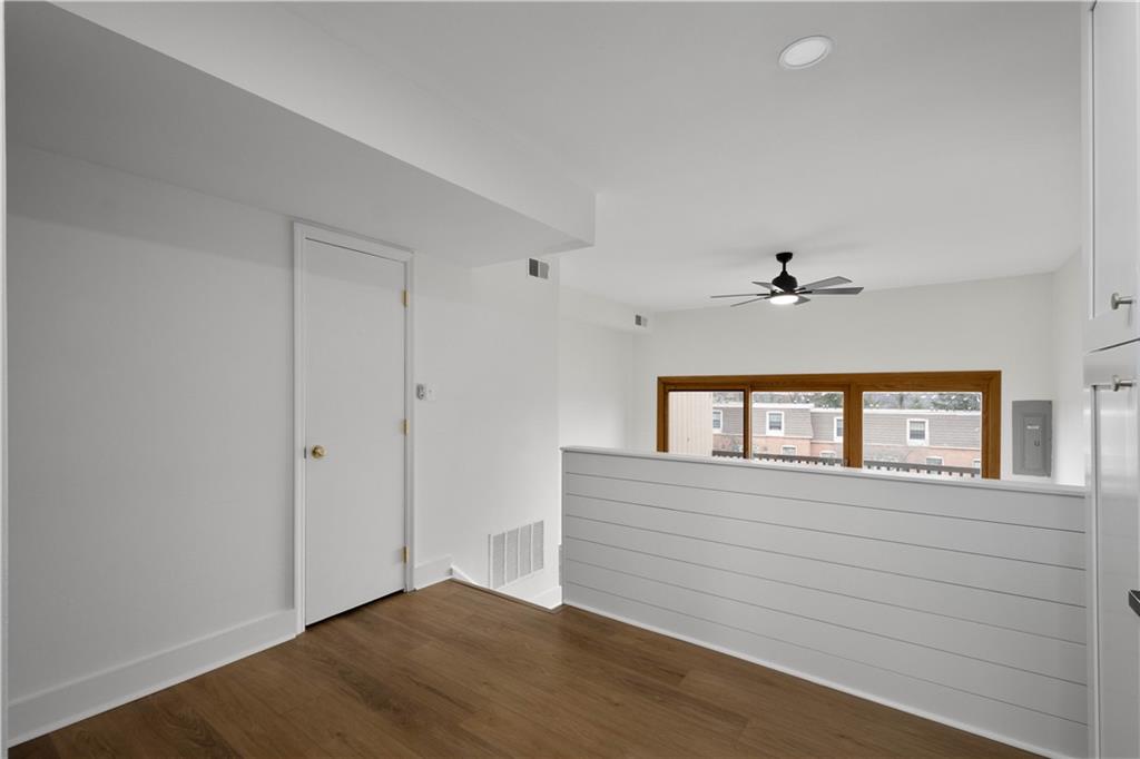 139 Community Court Pittsburgh, PA 15205 - Photo 13 of 32 a view of a livingroom with an empty space & a ceiling fan