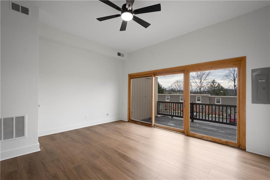 139 Community Court Pittsburgh, PA 15205 - Photo 15 of 32 an empty room with wooden floor fan and windows