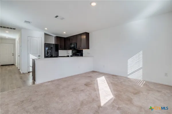 a view of a kitchen with a sink and cabinets