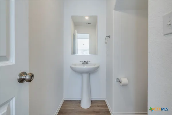 a bathroom with a sink a mirror and shower