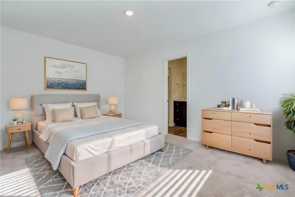 a bedroom with a bed and a dresser