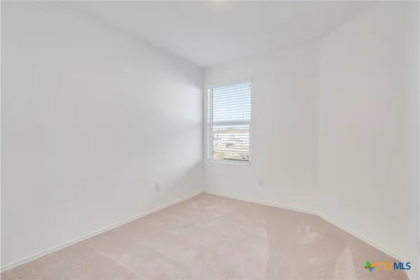 a view of an empty room and a window