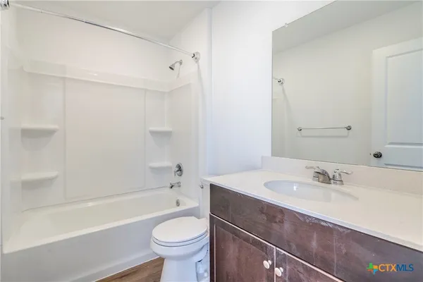 a bathroom with a sink a toilet and bathtub