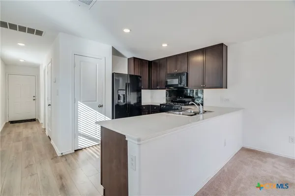 a view of kitchen with wooden floor