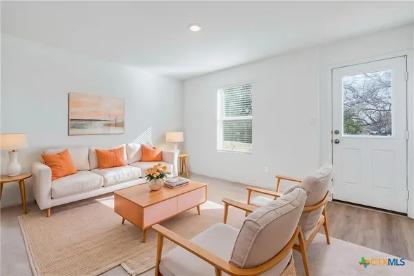 a living room with furniture a couch and a window