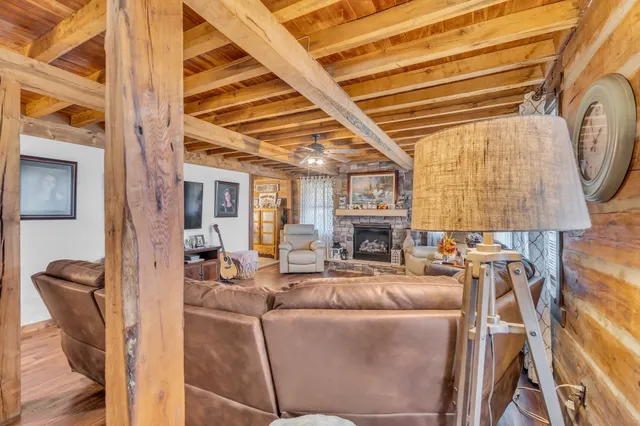 a living room with furniture a fireplace and a table