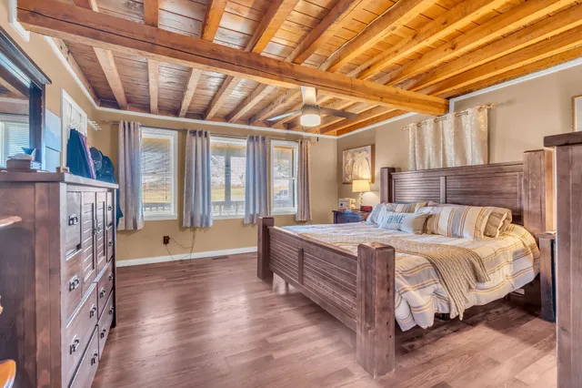 a spacious bedroom with a large bed and a chandelier